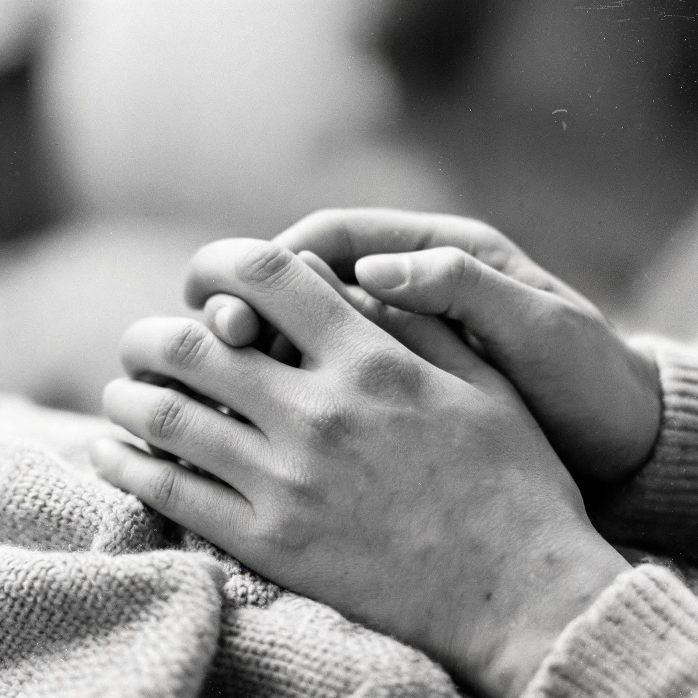 Hands raised in worship across the room